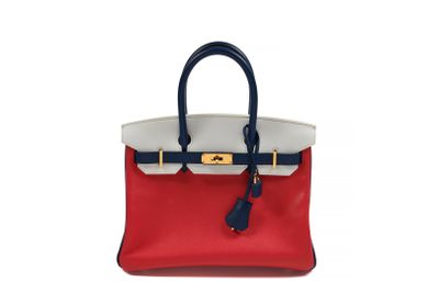 a red and white handbag with a blue handle