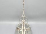 a silver plate with a tower on top of it