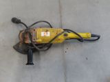 an image of a drill on the ground in a garage