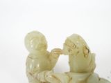two figurines of a man and a woman sitting on a boat