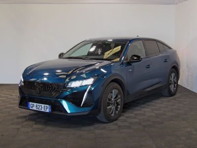 Le SUV bleu est garé dans une grande pièce au sol noir