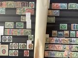 a lot of stamps that are on display on the wall