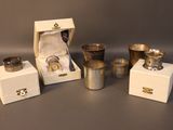 several silver cups and cups are sitting in a box on a table
