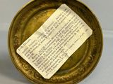a piece of paper that is in a brass bowl