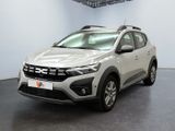 the front view of a silver car in a white room