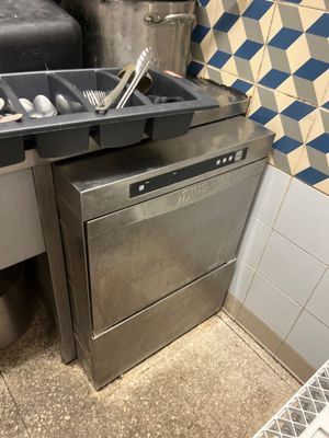 a silver dishwasher and a black dishwasher in a kitchen