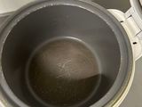 a metal bowl with a brown substance inside of it