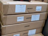 several boxes stacked on top of each other with a remote on top of them