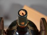 a bottle of wine with a cork in it sitting on a table