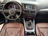 dashboard view of a car with brown leather seats and dashboard controls