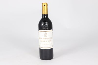 a bottle of red wine sitting on top of a white table