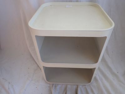 a small white table with two shelves on it