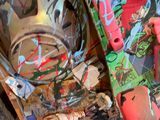 a skateboard that is covered in graffiti on the ground