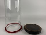 a close up of a glass bottle with a wooden lid