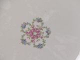 a white plate with pink and blue flowers on it