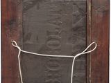 a close up of a wooden frame with a rope around it