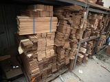 many stacks of cardboard on a shelf in a warehouse