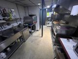 a large kitchen with many stainless steel appliances in it