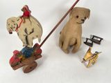 a wooden toy of a dog pulling a sleigh with a horse and a dog on it