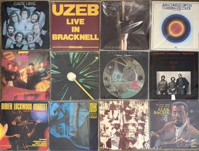 many different album covers on the wall of a room