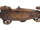 an old metal toy car with wheels and wheels on a white background