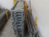 a pile of metal pipes in a room with a white wall