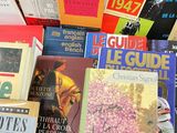 several books are stacked on top of each other on a table