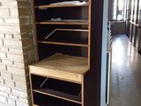 a shelf that has some clothes on it in a room