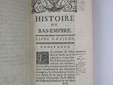 an open book on a white table with a picture of a bird on it