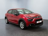 a red citrole is parked in a large room