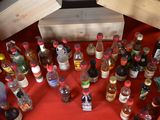 many bottles of alcohol sitting on a red table