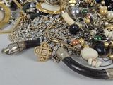 a pile of assorted jewelry on a table