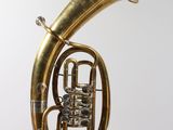 an image of a brass instrument hanging from a string