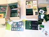several boxes of books are sitting on a table with a white table cloth