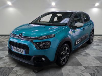 a blue citrole is parked in a room with a checkered floor
