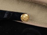 a close up of a hat with a button on it