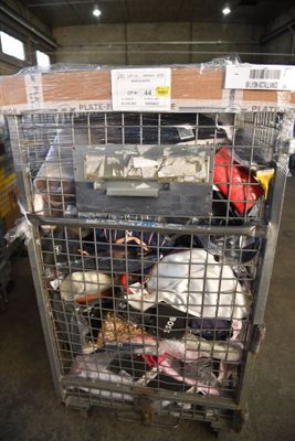 a metal cage filled with lots of items in a warehouse