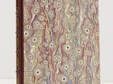 a book with a marbled cover on a white surface