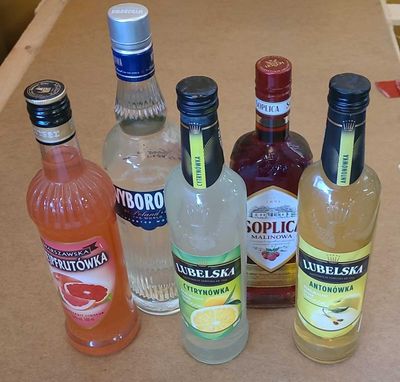 many bottles of alcohol sitting on a counter top