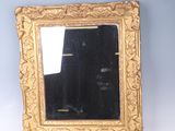 an image of a gold framed mirror on a white surface