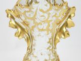 gold and white porcelain vase with ornate decoration on stand