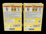 two boxes of cereal sitting next to each other on a black surface