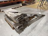 a pile of metal items on a pallet in a warehouse