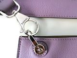 a close up of a purple purse with a metal clasp