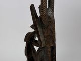 an image of a wooden sculpture of a bird on a stand