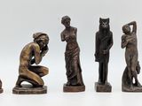 six bronze figurines of a man and a woman and a child
