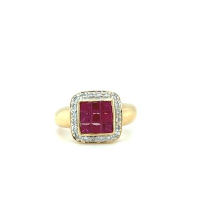 a close up of a gold ring with a ruby stone and diamonds