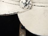 a close up of a white hat on a mannequin head