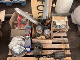 a pile of assorted items on a pallet in a garage