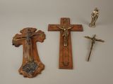 two crosses and a figurine of jesus on a table